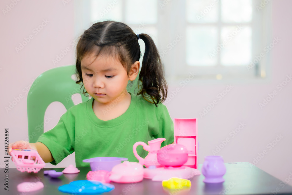 Kindergarten children in Asia are playing toys on the table. Kindergarten children in Asia are playing toys on the table.