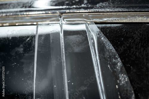 Scratched car window frame, covered with anti-gravel self-leveling film