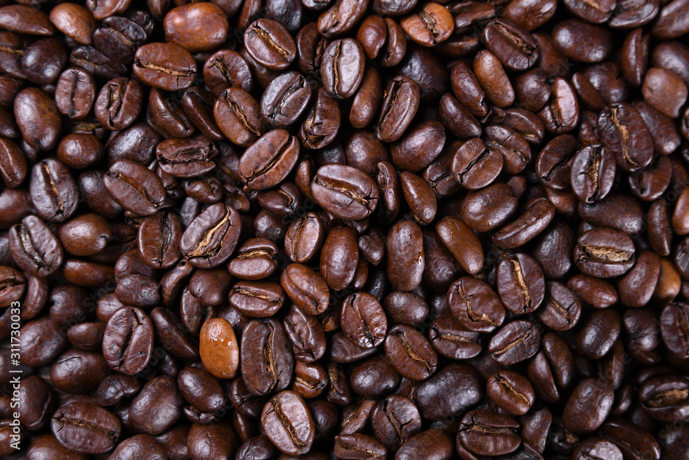 Naklejka premium Fresh brown coffee beans texture of roasted ready to drink close-up.