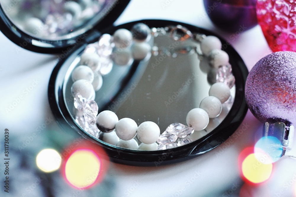 Jewelry composition with reflections in mirror with bokeh