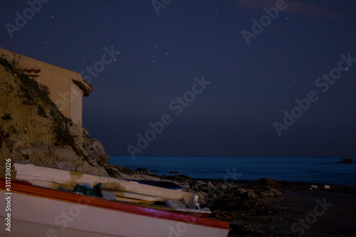 Boat on a beach at night