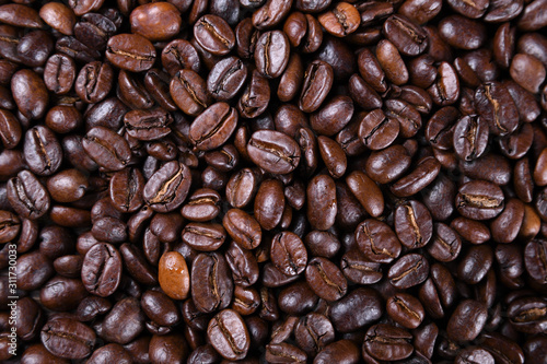 Fresh brown coffee beans texture of roasted ready to drink close-up.