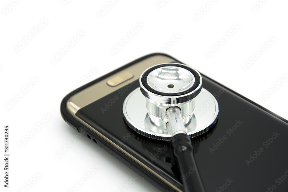 Phone repair and service concept.Smartphone being diagnosed with a stethoscope Phone repair and service concept.Smartphone being diagnosed with a stethoscope