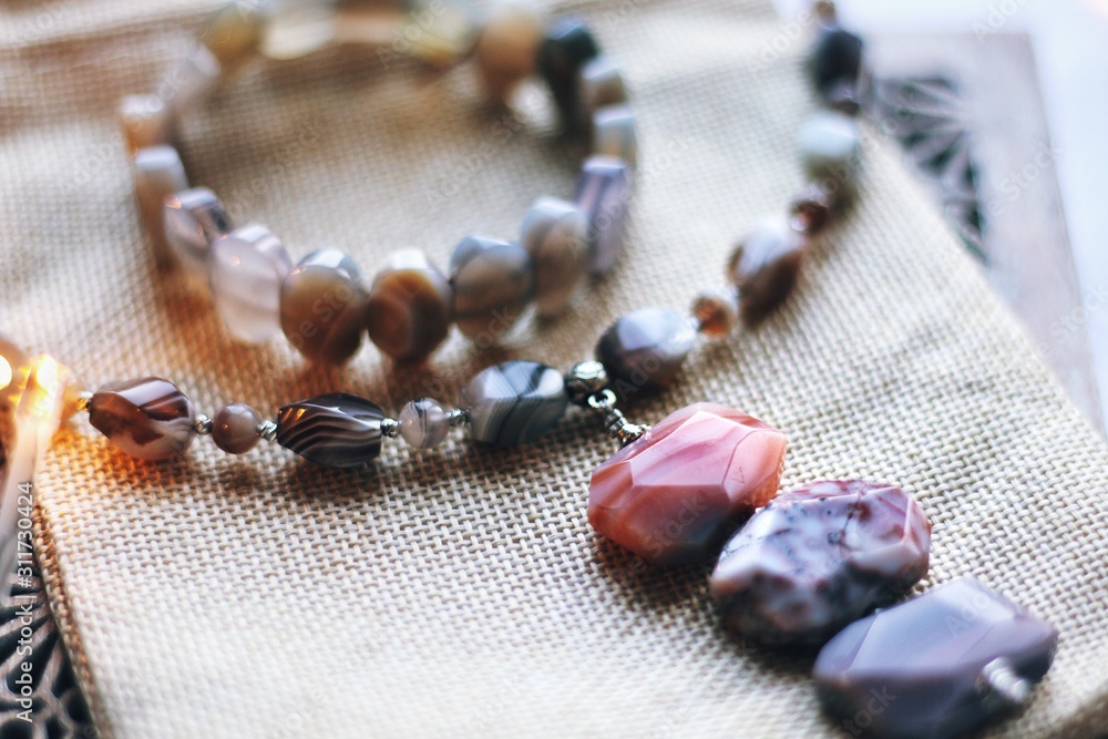 Jewelry composition on interior background with bokeh
