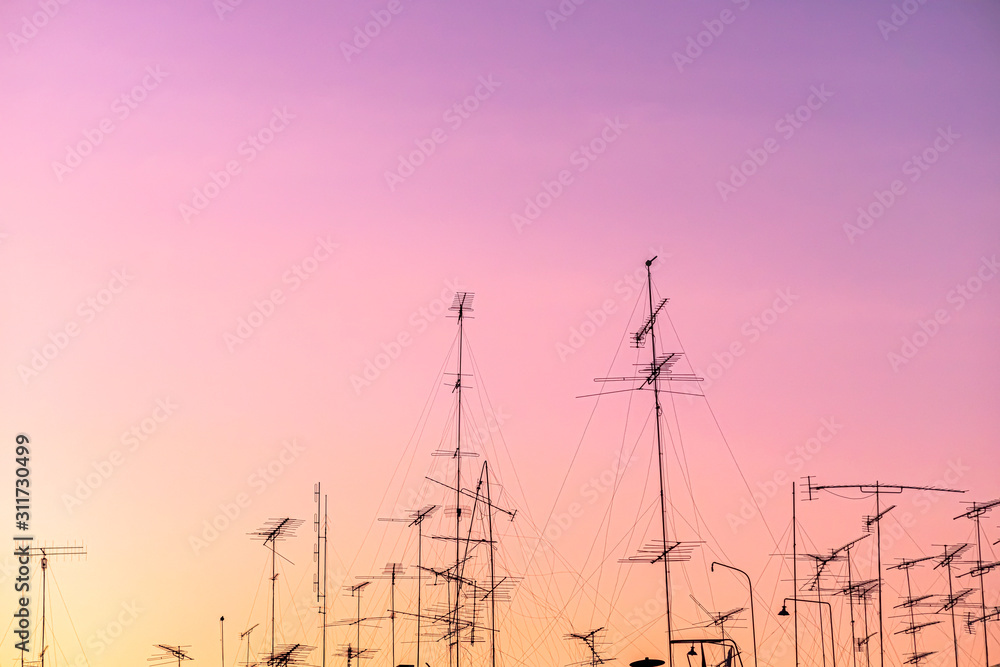 Fototapeta premium Beautiful view silhouette of television aerials(antennas) with the background at sunset time.