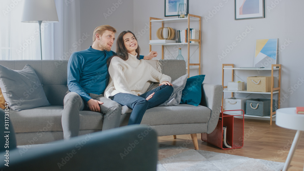 Template of Augmented Reality Usage: Young Couple Use Augmented Reality for Swiping and Choosing Media Content to Watch in their Living Room. Template of Augmented Reality Usage: Young Couple Use Augmented Reality for Swiping and Choosing Media Content to Watch in their Living Room.