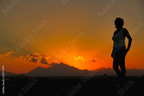 Woman on sunset background in Egypt