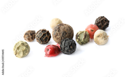 Mix of different pepper grains isolated on white