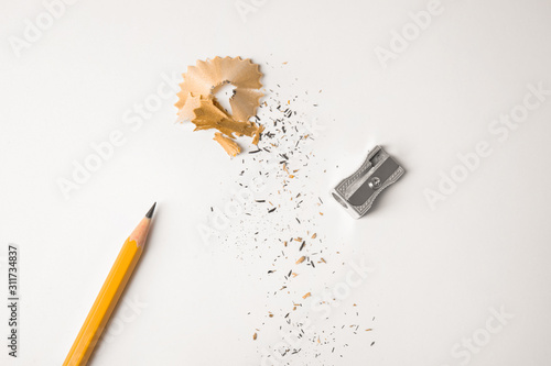 Photos Pencil, sharpener and shavings on white background, top view