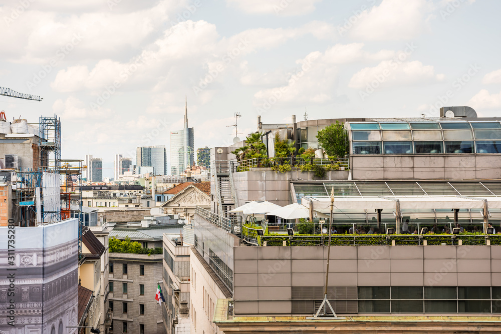   Aerial view of the old downtown of the Milan City with beautiful rooftops, view from the top of cathedral church of Milan, Lombardy, Italy.