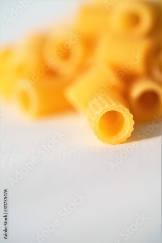 Close up view on dry Italian ditaloni pasta on white background photo