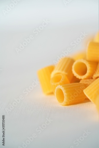 Close up view on dry Italian ditaloni pasta on white background photo