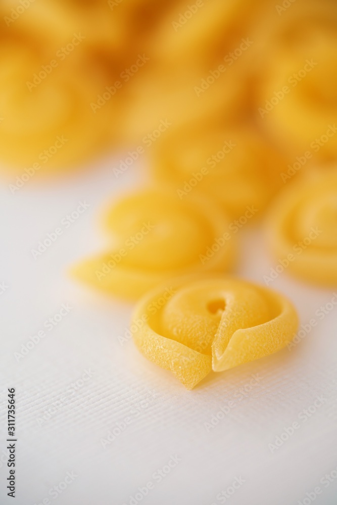 Top view on Italian messicani pasta shapes on white background Top view on Italian messicani pasta shapes on white background