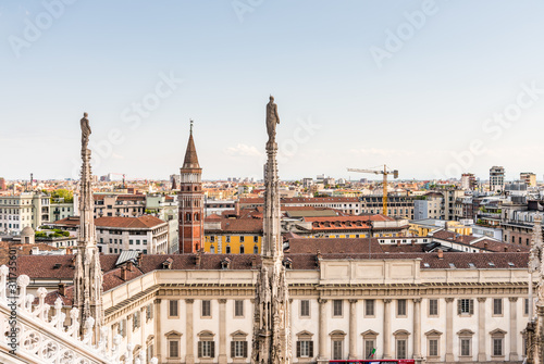 Architectural details with statues on the top of beautiful building of the Milan Cathedral (Duomo di Milano), the cathedral church of Milan, Lombardy, Italy. Dedicated to the Nativity of St Mary. © zz3701