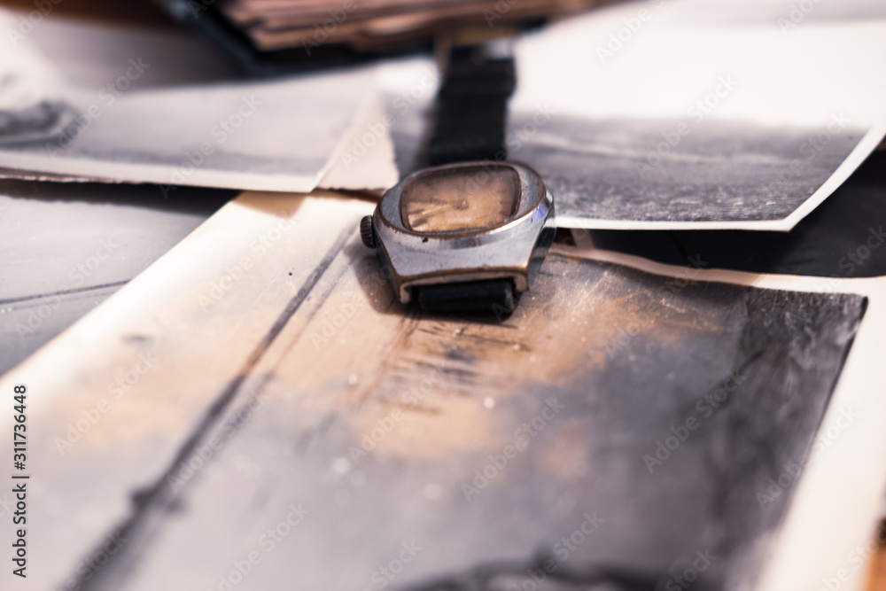 Old watch and photos, family ancestry, memories concept Old watch and photos, family ancestry, memories concept