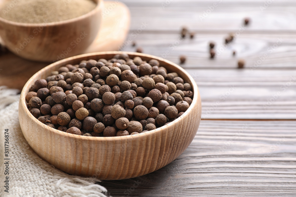 Peppercorns on light grey wooden table, closeup Peppercorns on light grey wooden table, closeup