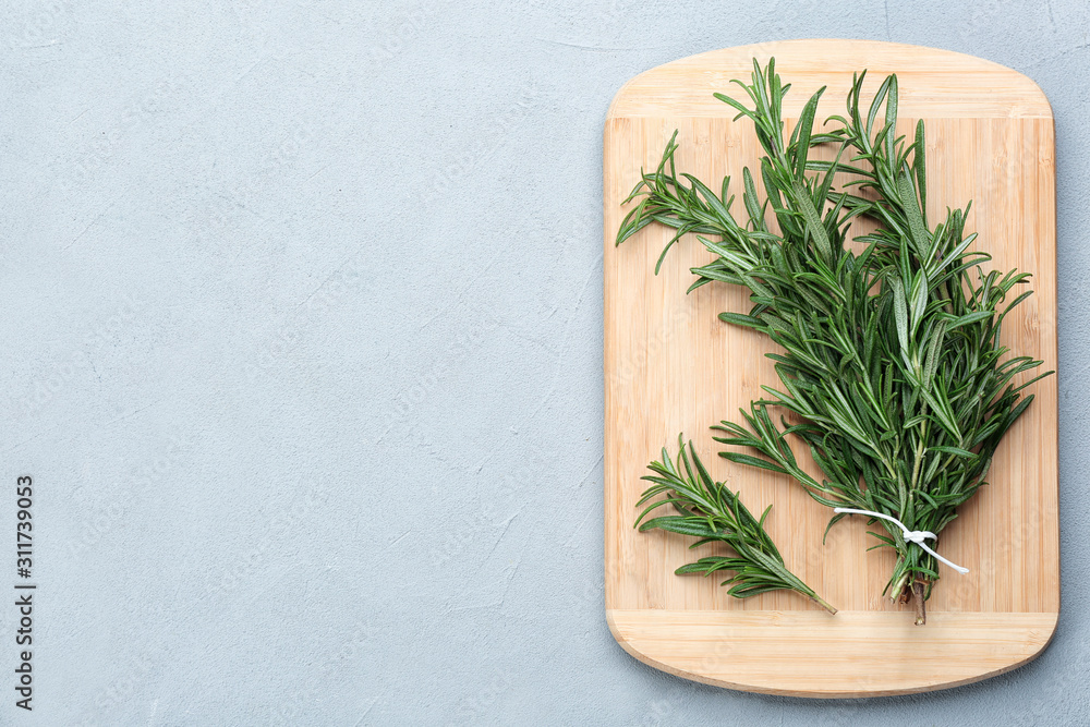 Bunch of fresh rosemary on light grey table, top view. Space for text Bunch of fresh rosemary on light grey table, top view. Space for text