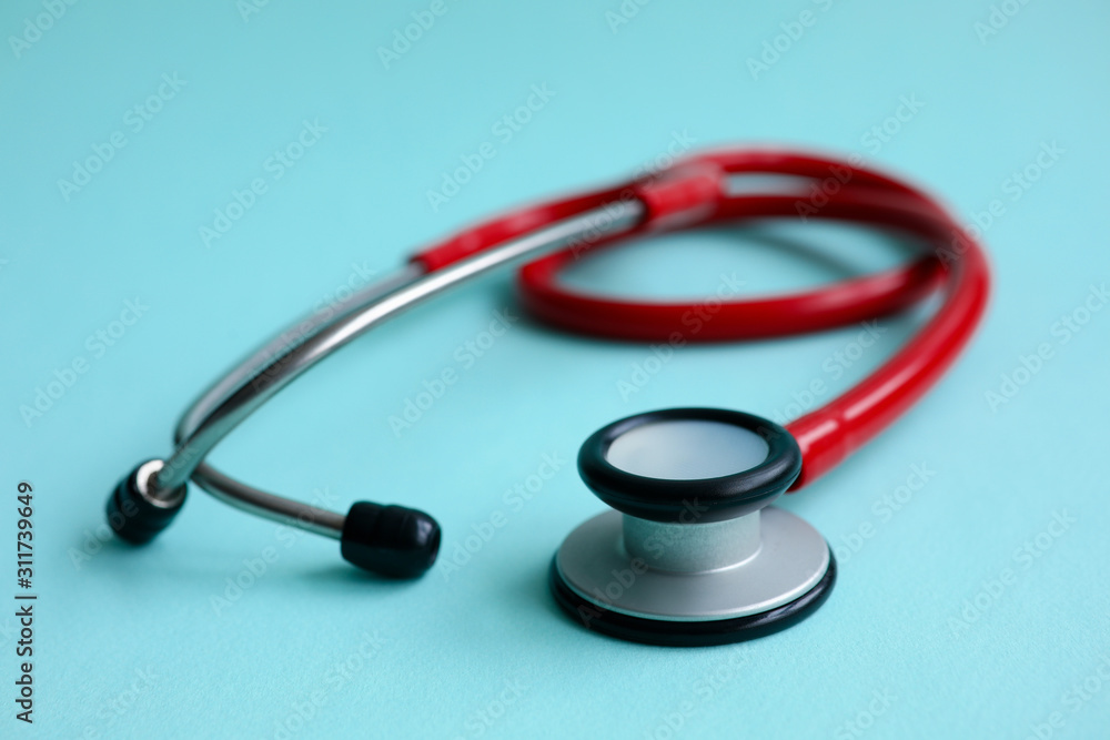 Red doctor stethoscope on blue modern background Red doctor stethoscope on blue modern background