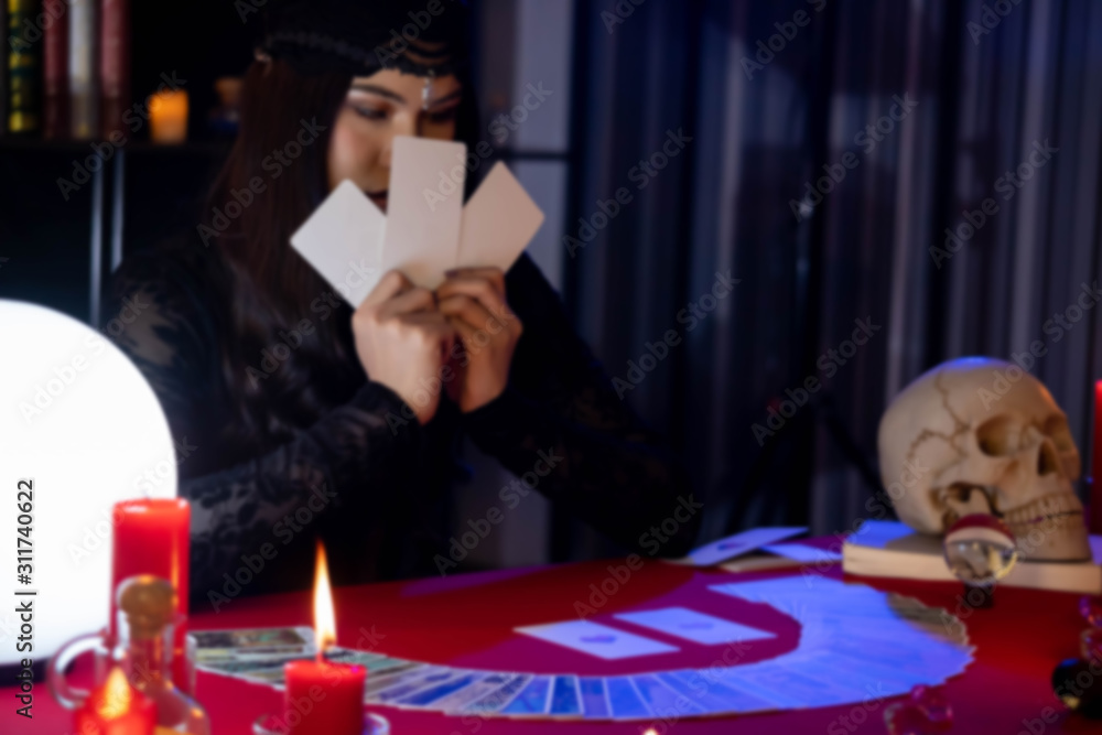 Fortune Teller young Asian woman Gypsy glowing crystal ball, tarot cards, magic, and composition esoteric astrology object to predict destiny or future. superstition and supernatural phenomenon