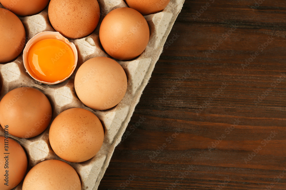 Raw chicken eggs on wooden table, top view. Space for text Raw chicken eggs on wooden table, top view. Space for text