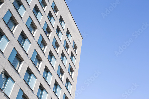 Beautiful architectural building with windows against the blue sky, copy space, place for text