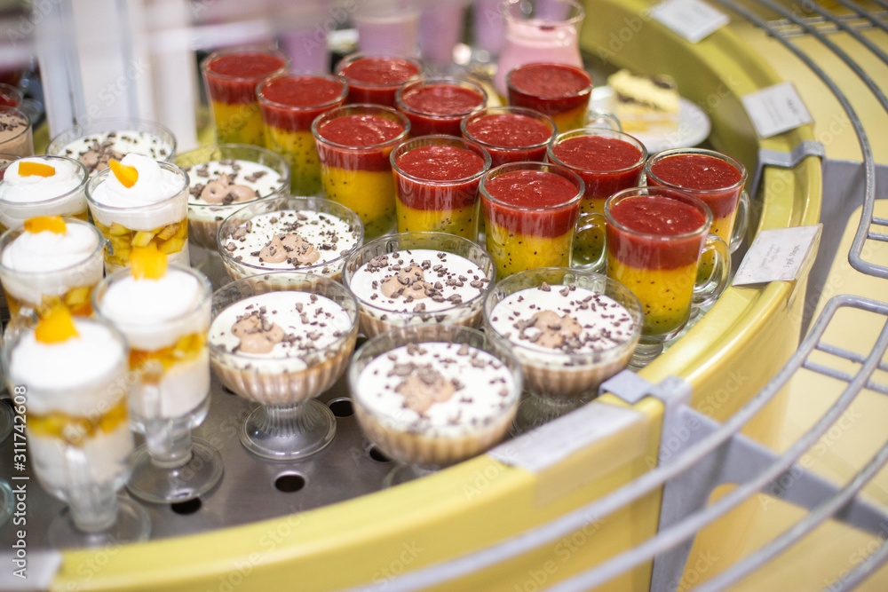 Sale of delicious multi-colored sweet desserts and souffl , background Sale of delicious multi-colored sweet desserts and souffl , background