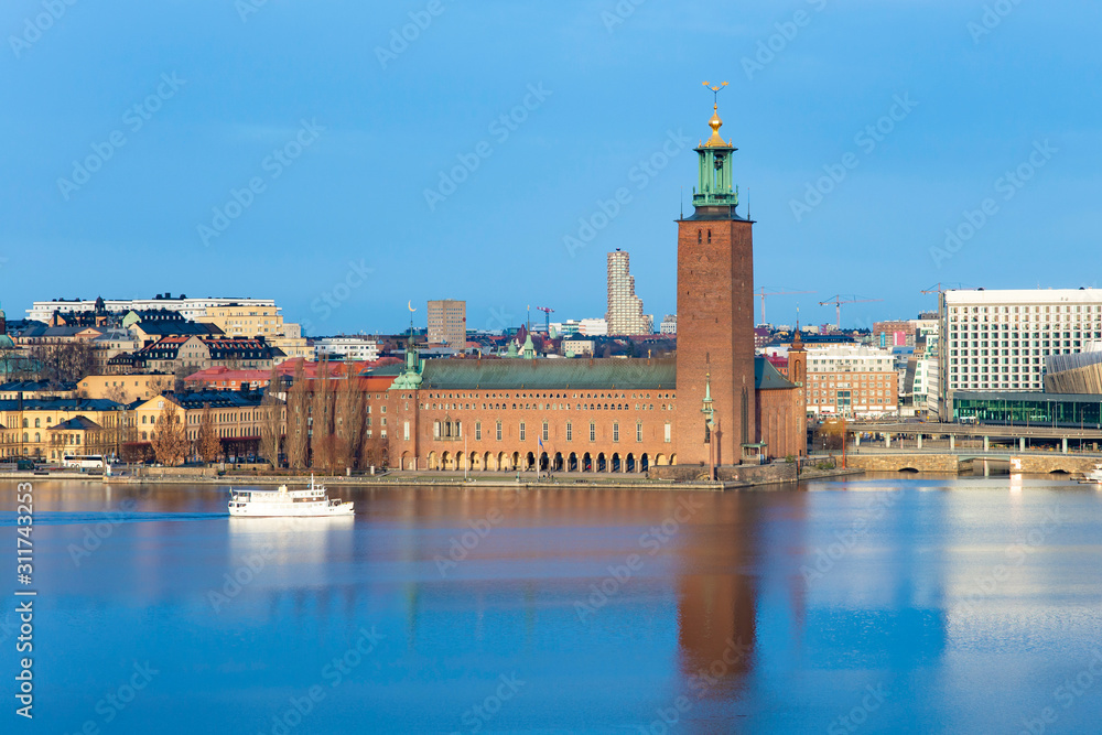 The city hall of Stockholm from above with sailing ship on the lake during sunny day and sky without clouds
