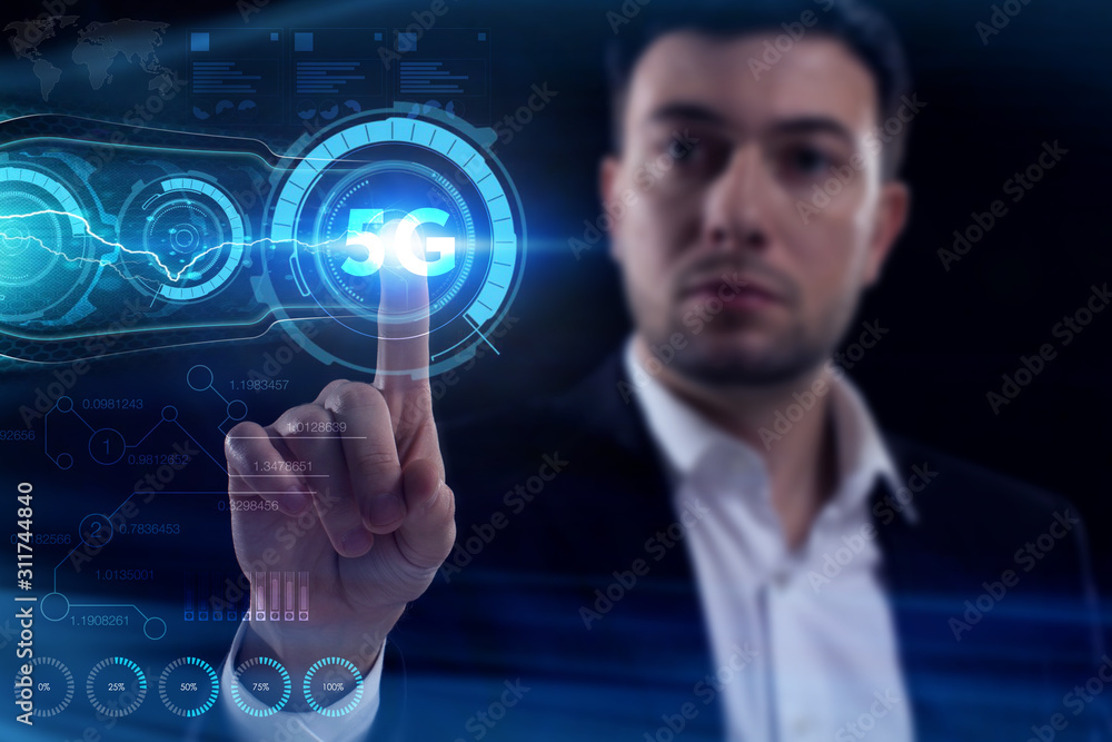 Business, Technology, Internet and network concept. Young businessman working on a virtual screen of the future and sees the inscription: 5G Business, Technology, Internet and network concept. Young businessman working on a virtual screen of the future and sees the inscription: 5G