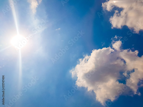 blue sky with white cloud and the sun in the nature
