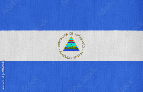 National flag of Nicaragua on a cotton texture background photo