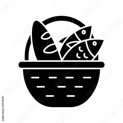 Bread and fish in basket glyph icon. Feeding the multitude. Holy week. Blessing food from Bible. New Testament. Bible narrative. Silhouette symbol. Negative space. Vector isolated illustration