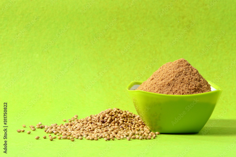 Coriander seeds and Powdered coriander in green container on green