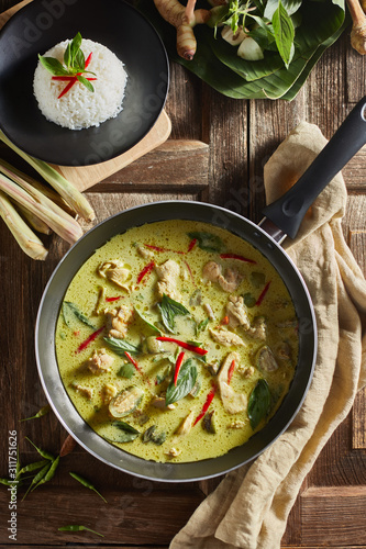 Thai food chicken green curry on wooden background. . photo