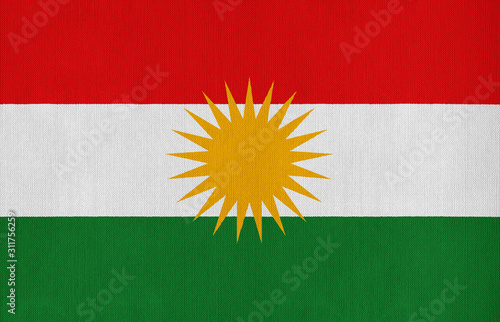 National flag of Kurdistan on a cotton texture background