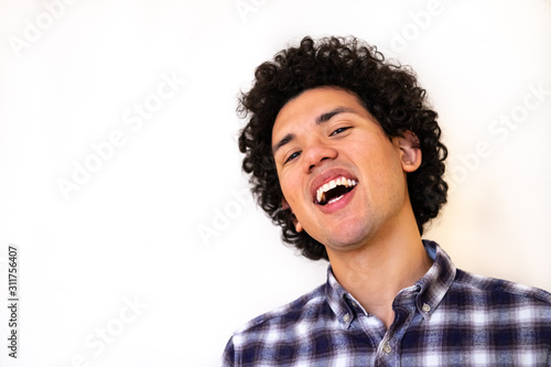 Latin american man looking joyful on a white background 
