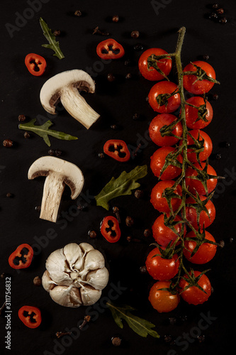 garlic, garlic on a black background with tomatoes and mushrooms