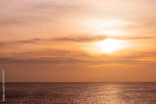 Sunset in cloudy sky, evening at sea