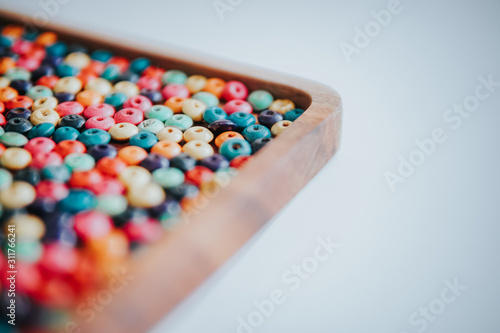 colorful beads on a wooden plate