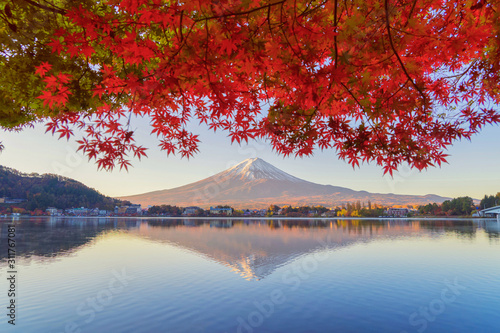 Mountain Fuji with red maple leaves or fall foliage in colorful autumn season near Fujikawaguchiko, Yamanashi. Five lakes. Trees in Japan with blue sky. Nature landscape background photo