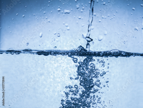 splash of water isolated on blue background