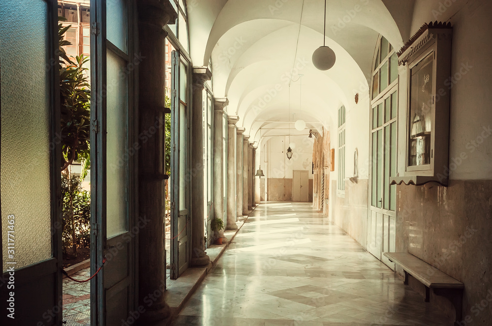 Corridor with open door to courtyard 0f 16th century Santa Caterina monastery, Palermo.