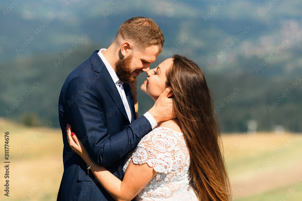 newlyweds standing face to face and look at each other in the na newlyweds standing face to face and look at each other in the na