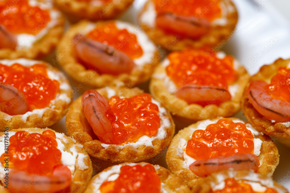 tartlets with red caviar on a plate tartlets with red caviar on a plate
