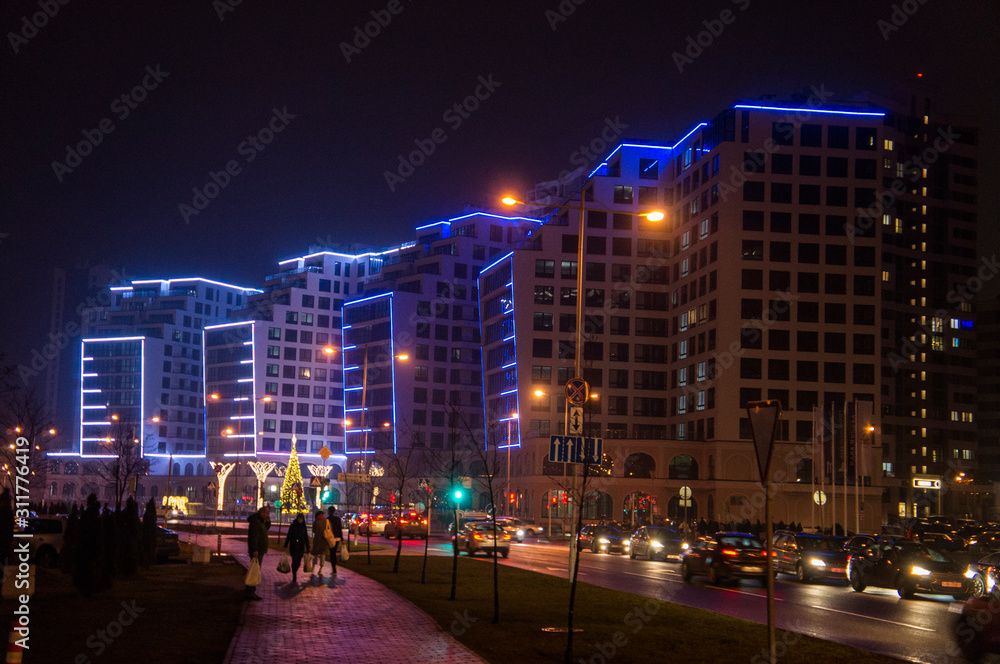 Obraz premium Glowing buildings at night. Illumination back Christmas and New Year. Minsk, Belarus. December 24, 2019