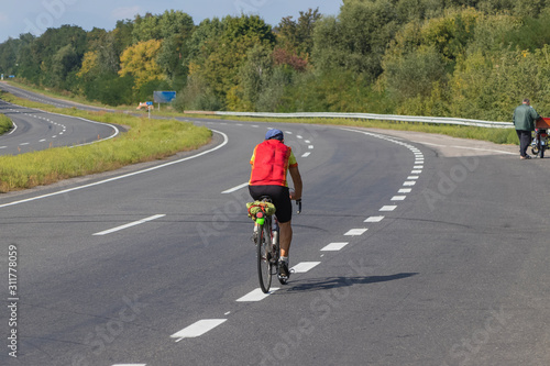 Cyclist rides on the highway on a bicycle