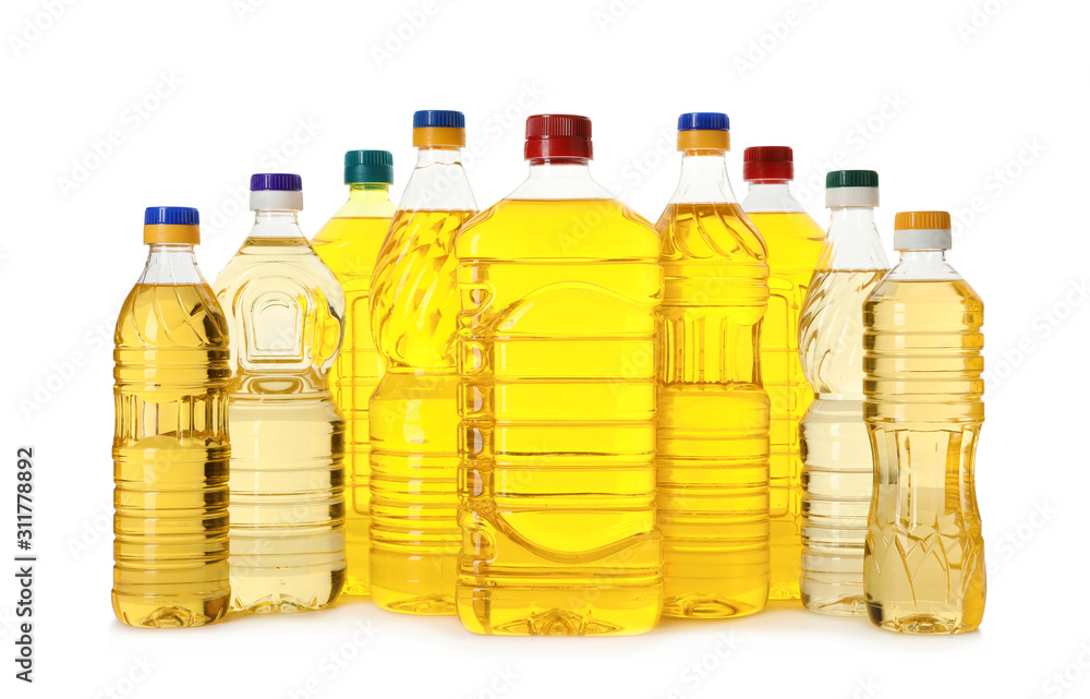 Cooking oil in different bottles isolated on white Cooking oil in different bottles isolated on white