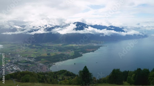 Forward take-off from observation deck to Lake Geneva view and Alps Mountains near Rochers-de-Naye place in Switzerland. Cloudy day