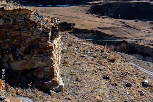 Stone remains of old abandoned balkar village in North Caucasus photo