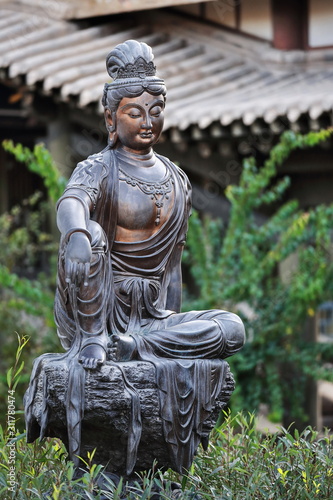 Bronze Buddha statue facing the Mingyue temple overlooking Crescent Lake-Dunhuang-Gansu-China-0672 photo