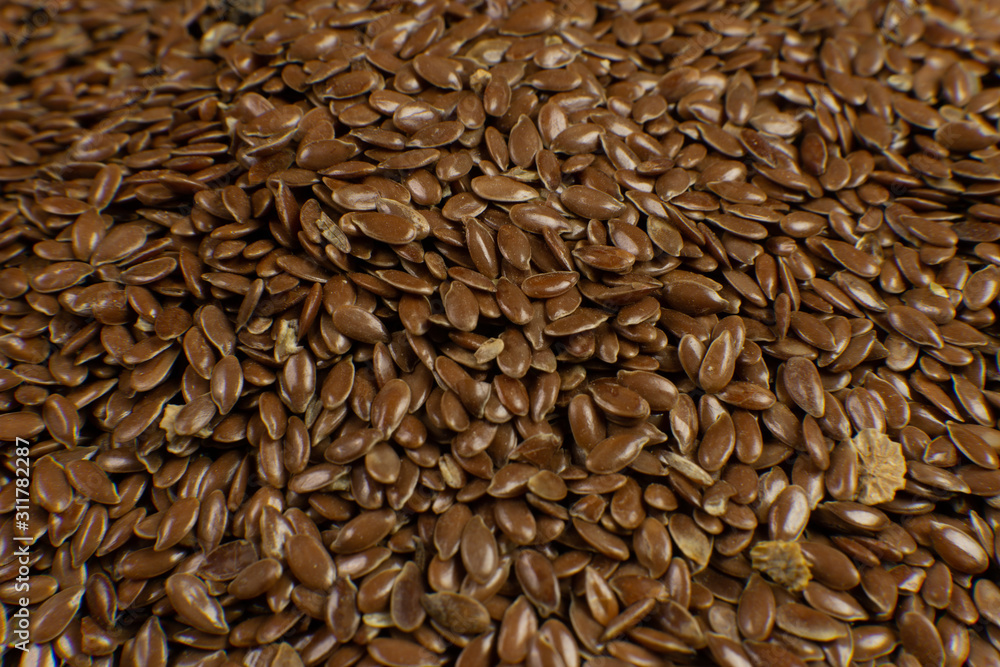 Linum usitatissimum is scientific name of Brown Flax seed. Also known as Linseed, Flaxseed and Common Flax. Closeup of grains, background. Linum usitatissimum is scientific name of Brown Flax seed. Also known as Linseed, Flaxseed and Common Flax. Closeup of grains, background.